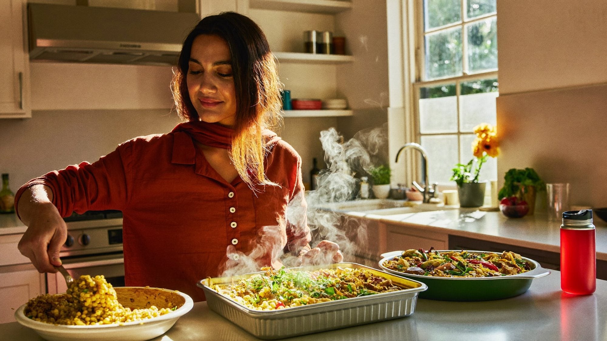 Portioning a home-cooked meal into a steel tiffin